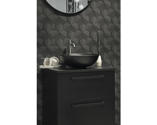 Modernt badrum med svart tvättställsskåp, tvättställsskål och geometrisk väggdesign.