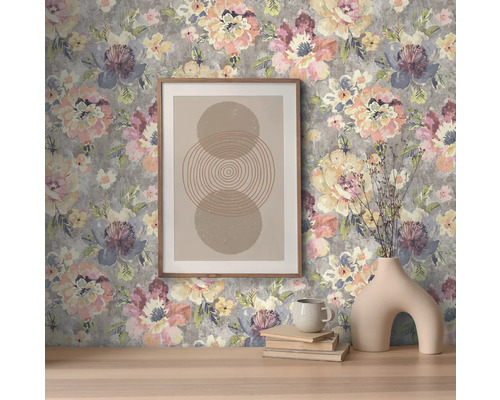 Dekorativ interiör med blommig tapet, inramad bild och vas.