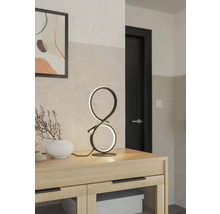 Dekorativ bordslampa i modern design på ett träskåp