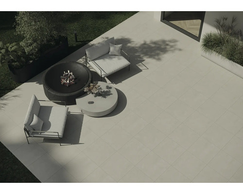 Översikt över en trädgårdsscen med fyrkantiga terrassplattor, eldstad, två fåtöljer och ett runt bord