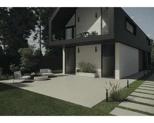 Modern husfasad med terrass, trädgårdsmöbler och gräsmattor