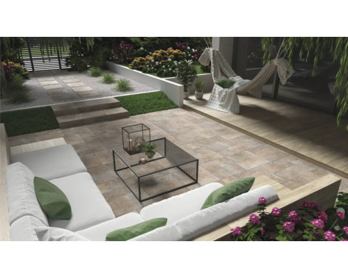 Anlagd trädgård med terrass, trädgårdsmöbler och dekorativa element.