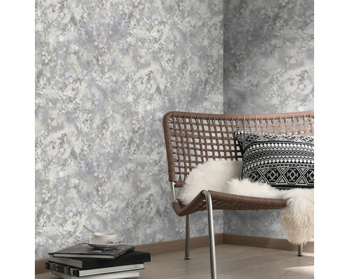 Dekorativ tapet med växtmönster i ett ljust rum med stol och tillbehör.