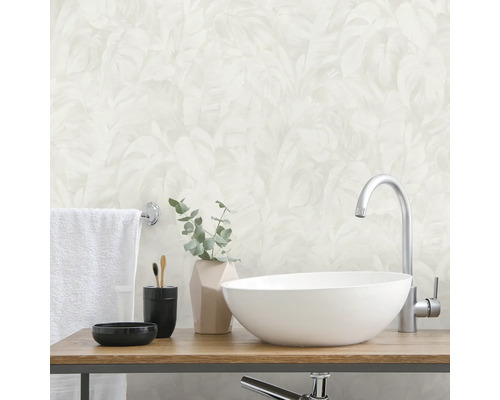 Badrum med tvättställsskål, blandare, handduk och tillbehör på en trähylla framför en mönstrad tapet