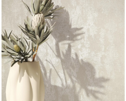 Dekorativ vas med växter på en strukturerad bakgrund