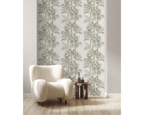 Miljöbild med fåtölj, bord och tapet med palmträdsmotiv