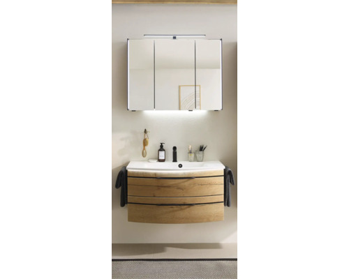 Badrum med tvättställsskåp, tvättställ och spegelskåp med belysning