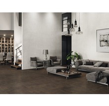 Rymligt vardagsrum med brunt golvkakel och ljust väggkakel, inrett med grå möbler.