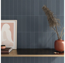 Väggdekoration med avlånga plattor och dekorativa element på en hylla