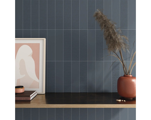 Väggdekoration med avlånga plattor och dekorativa element på en hylla