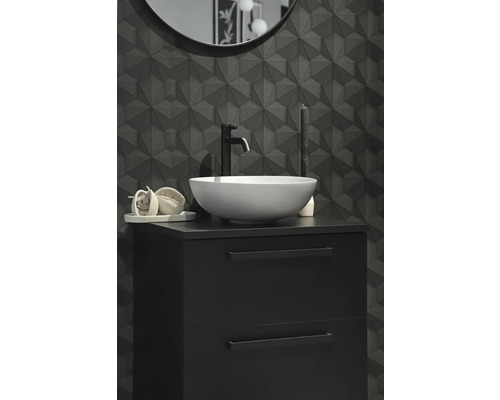 Modernt badrum med svart tvättställsskåp, tvättställsskål och tredimensionell väggplatta