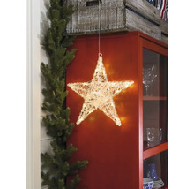 Dekorativ belyst stjärna framför ett skåp