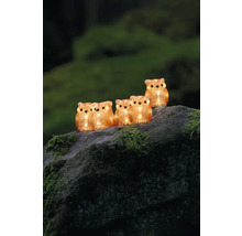 Dekorativ ljusslinga med ugglor av plast, placerad på en sten