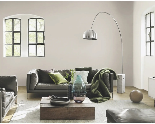 Vardagsrum med lädersoffa, golvlampa och träbord