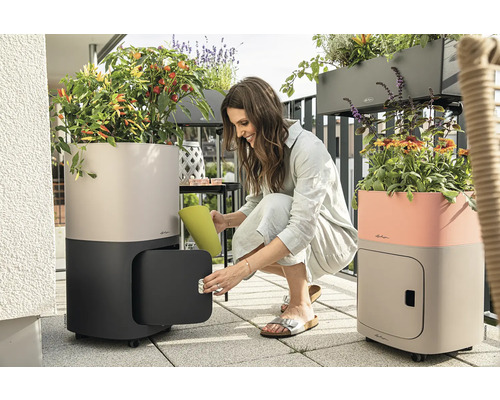 Kvinna öppnar växtlåda med förvaringsutrymme på balkongen