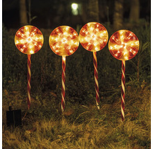 Fyra lysande solcellsdrivna klubbor som trädgårdsdekoration i gräset