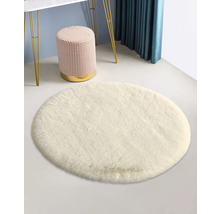 Vit rund matta med pall och bord i bakgrunden