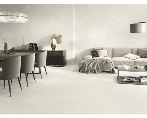 Ljust vardagsrum med klinkergolv i marmorlook, soffa, matbord och belysning
