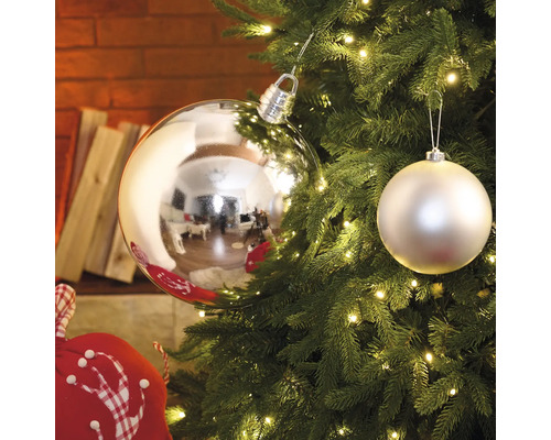 Julgran med silverfärgade och vita bollar samt ljusslinga