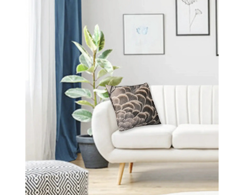 Dekorativ kudde med fjäderdesign på en soffa i ett vardagsrum