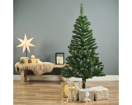 Dekorativt arrangemang med konstgjord julgran och presenter