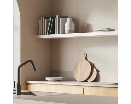 Köksscen med diskho, kran, hyllor och tillbehör.