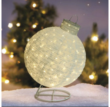 Dekorativ, belyst julkula med snöflingamönster på ett stativ