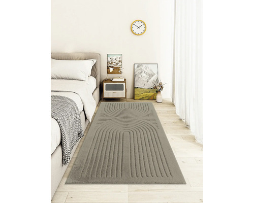 Sovrum med säng och grå matta med mönster