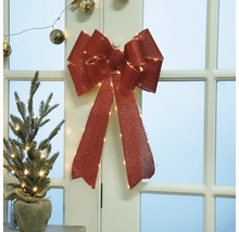 Dekorativ juldekoration med rosett och mini julgran