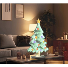 Dekorativ julgran med stjärna och kulor på bordet