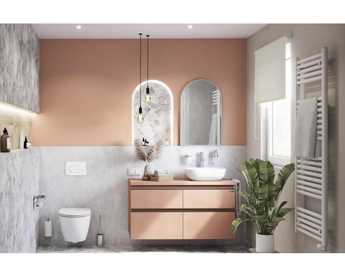 Modernt badrum med tvättställ, spegel, toalett och radiator