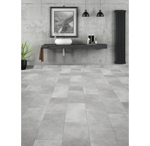 Modernt badrum med tvättställ, handfat, radiator och klinkergolv.