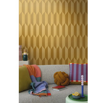 Miljöbild med en soffa och en vägg med geometrisk tapet