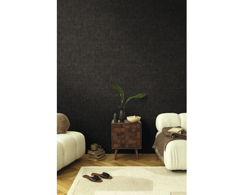 Vardagsrum med mörk tapet, nattduksbord och sittmöbler för en mysig atmosfär.