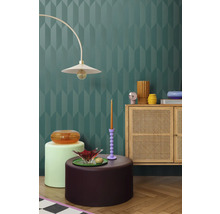 Interiör med dekorativ vägg, lampa, byrå och dekorativa element för en stilfull atmosfär.