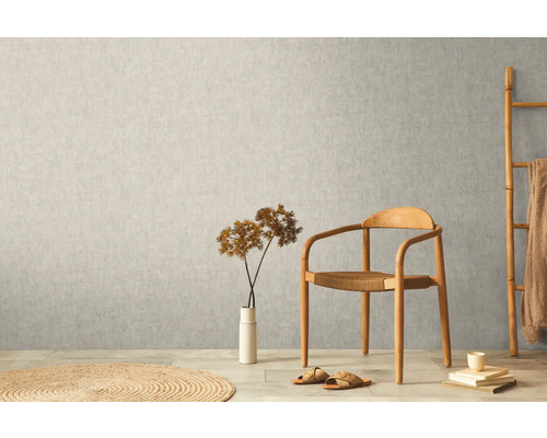 Scen med non-woven tapet på väggen, stol, dekoration och matta.