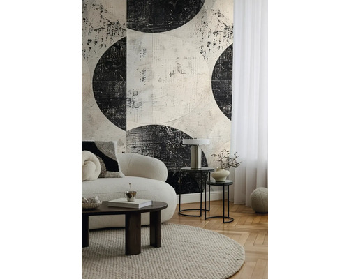 Vardagsrum med soffa, matta, sidobord och mönstrad tapet