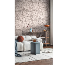 Vardagsrum med mönstrad tapet, soffa, sidobord och hylla