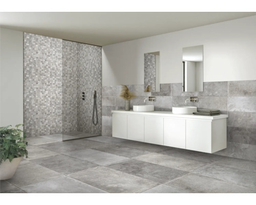 Modernt badrum med gråa plattor, duschkabin och tvättställsskåp