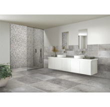 Modernt badrum med gråa plattor, duschkabin och tvättställsskåp