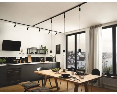 Modernt kök med svarta köksskåp, träbord och svart skensystem med spotlights och hänglampor