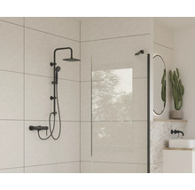 Modernt badrum med svart duschset, duschvägg och oval spegel