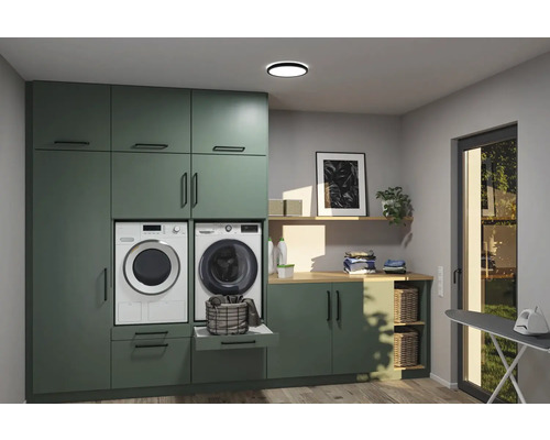 Tvättstuga med tvättmaskin, torktumlare, skåp, arbetsbänk och strykbräda