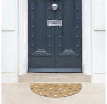 Halvrund dörrmatta framför en ytterdörr med prickmönster