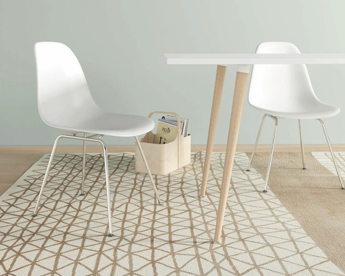 Scen med två stolar och ett bord på en mönstrad matta