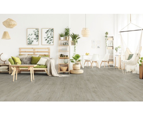 Ljust vardagsrum med trägolv, soffa, bord och hängande korg