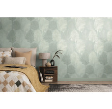 Sovrum med mönstrade tapeter och en säng med kuddar och en filt