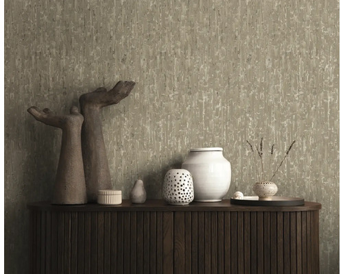 Dekorativ tapet med abstrakt mönster på en vägg ovanför ett skåp med dekorativa föremål