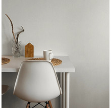 Vitt bord med dekorationer, inklusive ett glas, ett trähus och en mugg