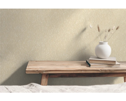 Vägg med non-woven tapet, böcker och blomvas på ett träbord